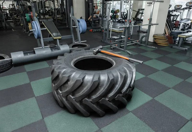 Bulky Tire on Gym Floor with Rubber Mat Tiles