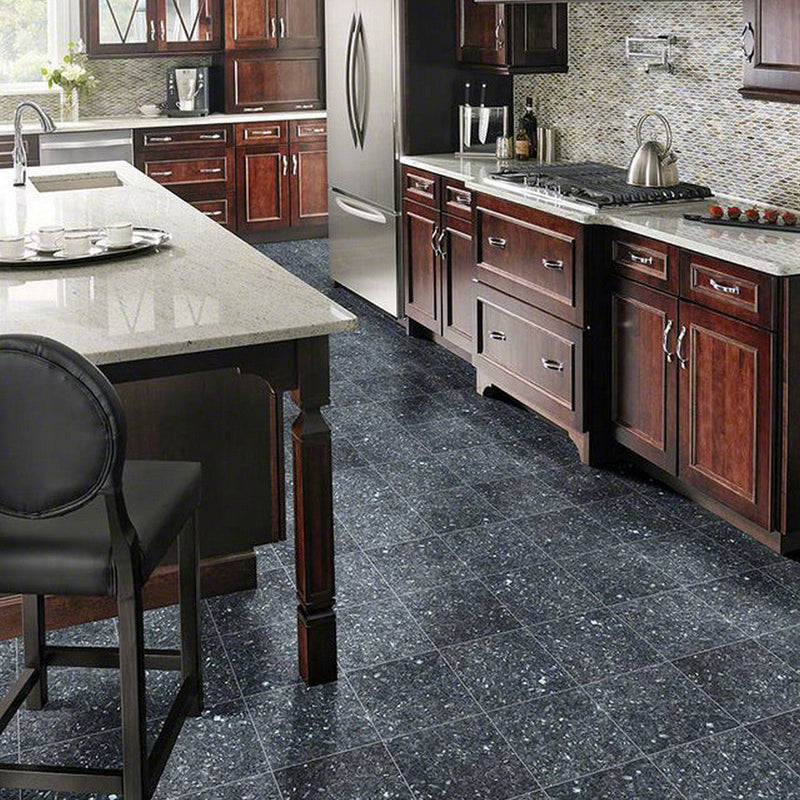 MSI Blue Pearl Granite Tile, MSI 12x12 Blue Silver Shmmering Tile, MSI Granite Tile, 12x12 Shimmering Tile, Image is showing a  kitchen with wooden cabinets, backsplash tiles on walls, a counter tap with granite, and a granite tiles on floor