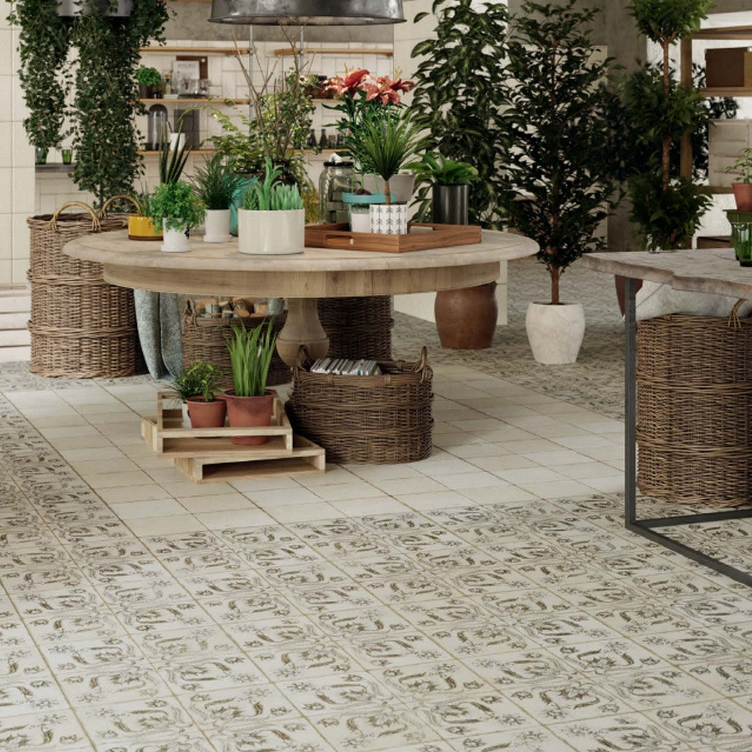 Rickert Pironda Title in Outdoor Location, Image is showing Ricker geometric tile installed on the floor, with a decor table and decor plants as an outdoor display, Floors Center